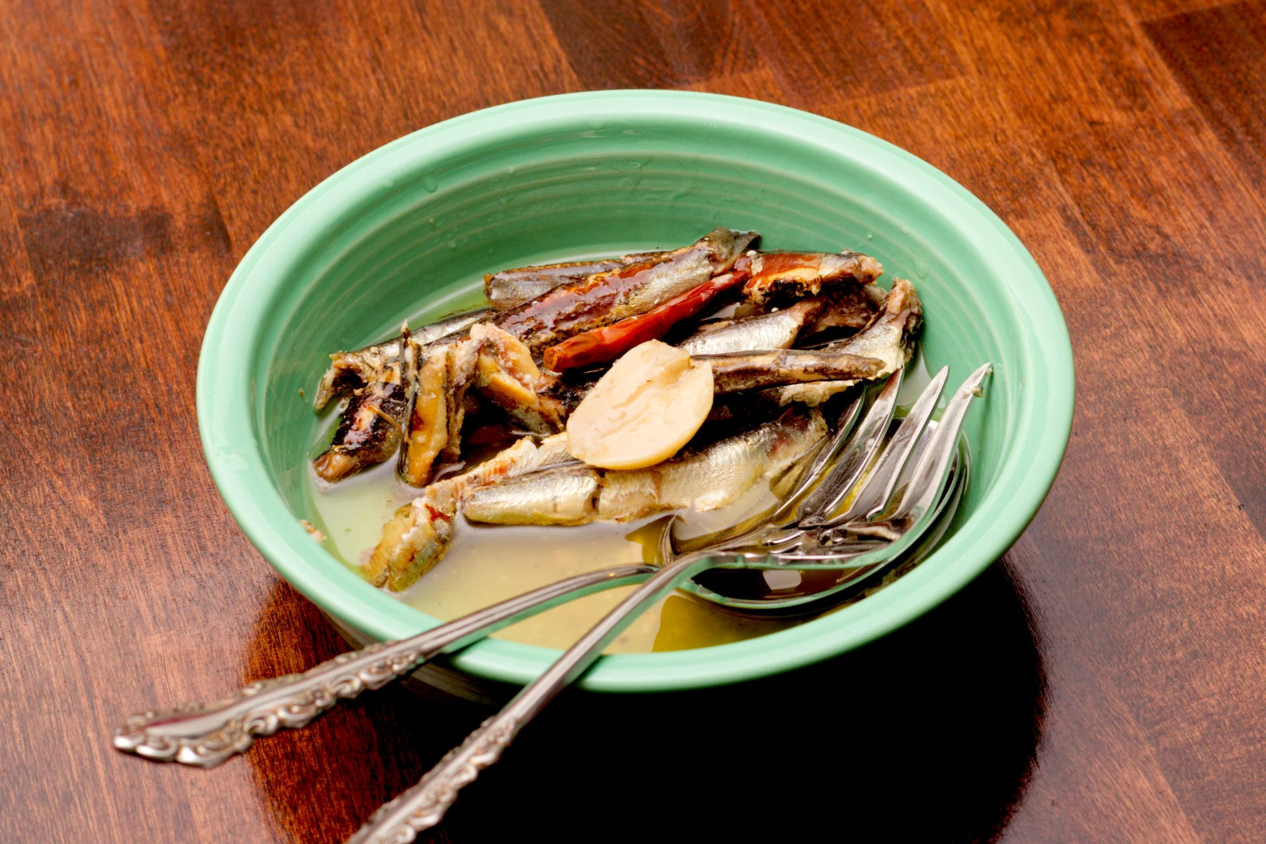 Anchovies in a dish with garlic and cayenne
